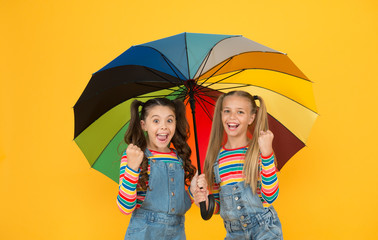 Safe place. Fashion accessory. Girls friends with umbrella. Rainy day. Happy childhood. School time. Rainbow umbrella. Colorful life. Schoolgirls happy umbrella. Fall weather forecast. Safety concept