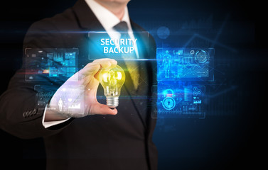Businessman holding lightbulb with SECURITY BACKUP inscription, online security idea concept