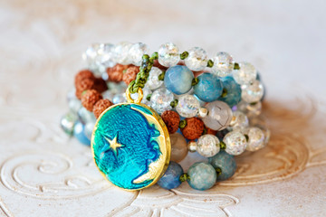 Spiritual mala bead necklace with natural mineral stone beads on wooden decorative background