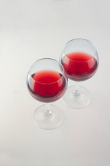  red wine in two glasses on a light wooden background vertical orientation
