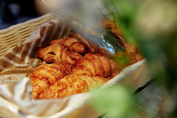 puff croissants folded in a wicker basket, pastry bakery, fresh buns