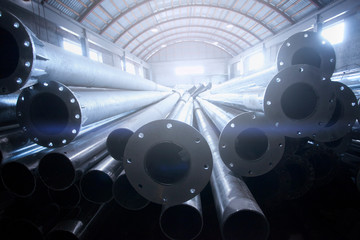 Metal warehouse indoor of steel pipes with flange. Storage of metal galvanized...
