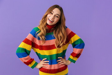 Cute cheerful young girl wearing colorful sweater standing