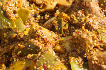 Spicy Hot Tangy Green Mango Ginger Garlic Pickles Soaked in Oil Close-Up Indian Aam Ka Aachar