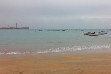 Obraz premium Cadiz sea beach with fishing boats, Spain