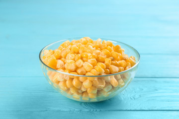 Frozen sweet corn on light blue wooden table. Vegetable preservation