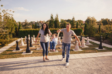 Family having fun near giant chess piece.