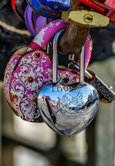 Lovers close the lock on the bridge post, and the key is thrown into the river.