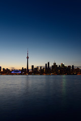 Fototapeta na wymiar Toronto city skyline at dusk on a clear night with blue sky over Lake Ontario