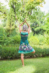 The back view, the girl practicing yoga and practicing yoga postures, amazing yoga postures in grass