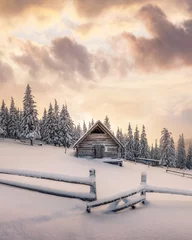 Fotobehang Fantastic winter landscape with wooden house in snowy mountains. Christmas holiday concept. Carpathians mountain, Ukraine, Europe © Ivan Kmit