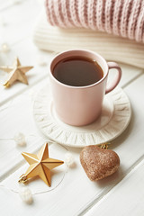Christmas decor, balls, woolen plaid on the window background, home comfort concept, seasonal winter celebrations. Postcard Template. Christmas pink cup