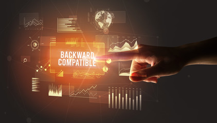 Hand touching BACKWARD COMPATIBLE inscription, new business technology concept