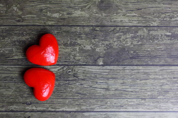 two stones in the shape of a heart on  wooden background - Valentine's Day card Concept