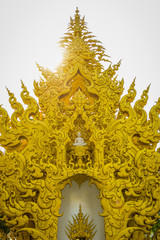 Yelllow ornate architecture with white Buddha