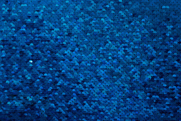 Sparkling Christmas background from blue glittering sequins with place for text