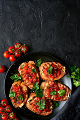 Grilled toasts with tomato salsa. Top view with copy space.