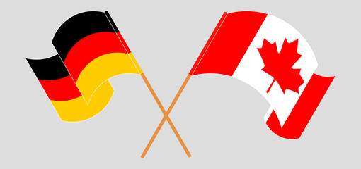 Crossed and waving flags of Canada and Germany