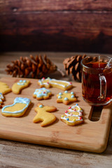 Christmas cookie on a wooden background.Tasty homemade Christmas cookies on wooden board, closeup view. Tasty colorful Christmas cookies. Vertical copy space