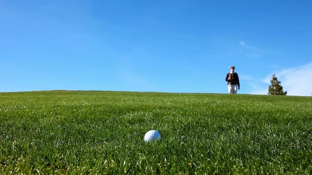 Cheating golfer kicking the ball to improve his lie