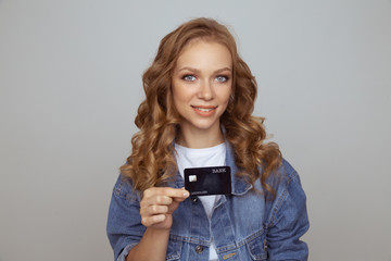 Fototapeta premium Closeup photo of woman with black credit card isolated