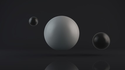 3D rendering of a large glowing white sphere and two black balls placed side by side. The objects are in a dark Studio. Abstract composition of ideal figures, a combination of white and black.
