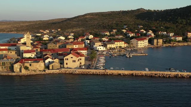Vinjerac, Croatia waterfront in golden evening light, tracking aerial