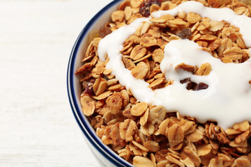 Muesli with yogurt in bowl, closeup. Delicious breakfast