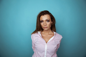 Portrait of handsome brunette woman in the blue studio