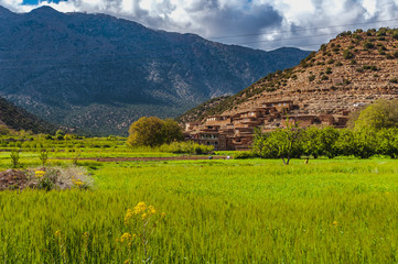 Fototapeta premium View of adobe houses in the high snow-capped mountains in the Aït Bouguemez valley in Morocco