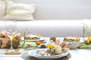 The interior of the room with a festive Easter table .