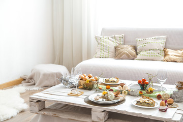 The interior of the room with a festive Easter table .