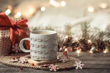 Festive background with Cup on wooden background with lights.