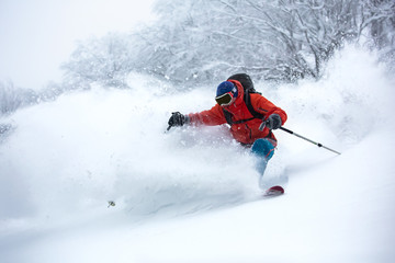 A skier is in the deep snow.