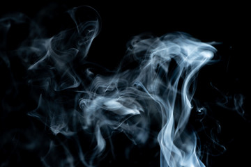 White waves of smoke drifting up abstract on a black background