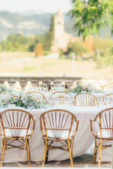amazing view of a Beautiful wedding table with the tuscany landscape as backdrop, italy
