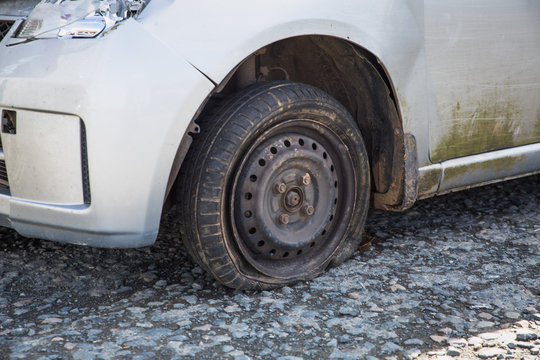 London, England Small Hatchback Car Left Derelict In A Gravel Carpark After A Road Traffic Collision. Insurance Not Called To Fix The Broken Down Wreck And So The Written Off Car Has Been Abandoned