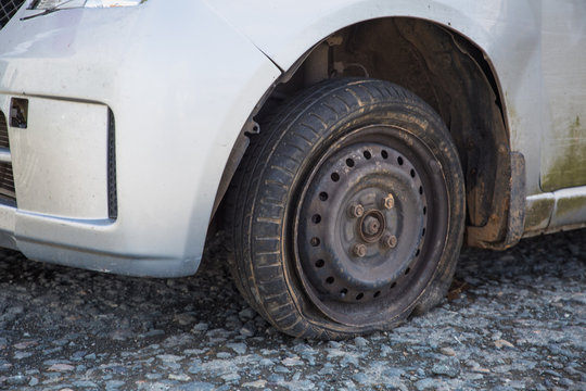 London, England Small Hatchback Car Left Derelict In A Gravel Carpark After A Road Traffic Collision. Insurance Not Called To Fix The Broken Down Wreck And So The Written Off Car Has Been Abandoned