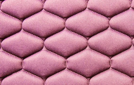 Detail of a pink blanket with square stitching © LauraFokkema