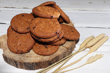 Oatmeal cookies with ears on an old wooden table, concept of a traditional bakery, selective focus. Useful natural breakfast without preservatives, healthy lifestyle, rustic style