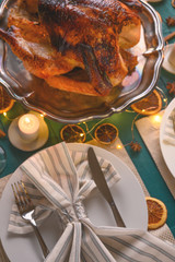 Christmas table, festive baked turkey, and served table. Vertical frame