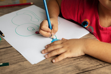 little girl playing games and draws a picture