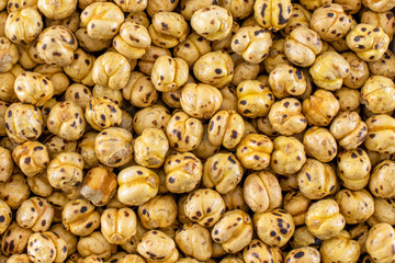 Roasted chickpeas close-up shot. Full frame roasted chickpeas, top view.