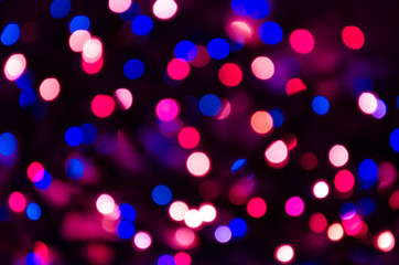Colorful abstract blurred pink and blue bokeh on black background