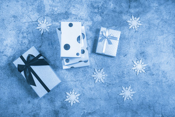 Gift boxes in blue monochrome tint. New Year and Christmas composition. Shot from above.