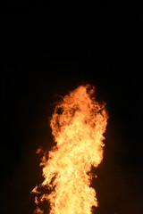 Fototapeta na wymiar Big Bonfire by Night with Orange Glowing Flames