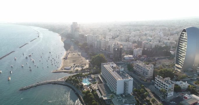 Aerial view of the Mediterranean coast line and Limassol city center. Limassol seaside, yacht marina and water sport recreation. Drone view of the coastal city in a day time. Limassol, Cyprus.