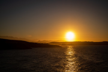 Comillas, Cantabria, northern Spain. Sunset over the ocean.