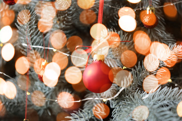 Beautiful decorated Christmas tree and blurred lights, closeup