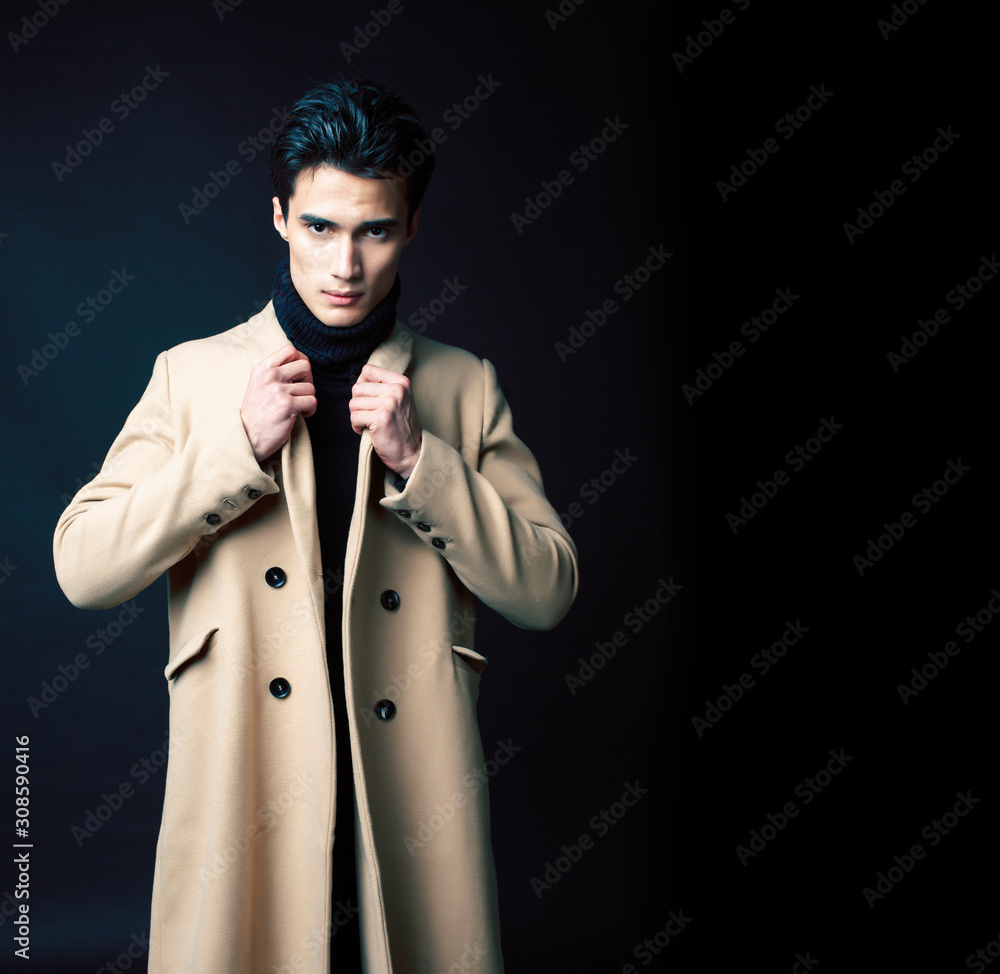 Wall mural handsome asian fashion looking man posing in studio on black background, lifestyle modern people con